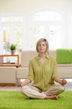 Woman doing yoga meditation at home